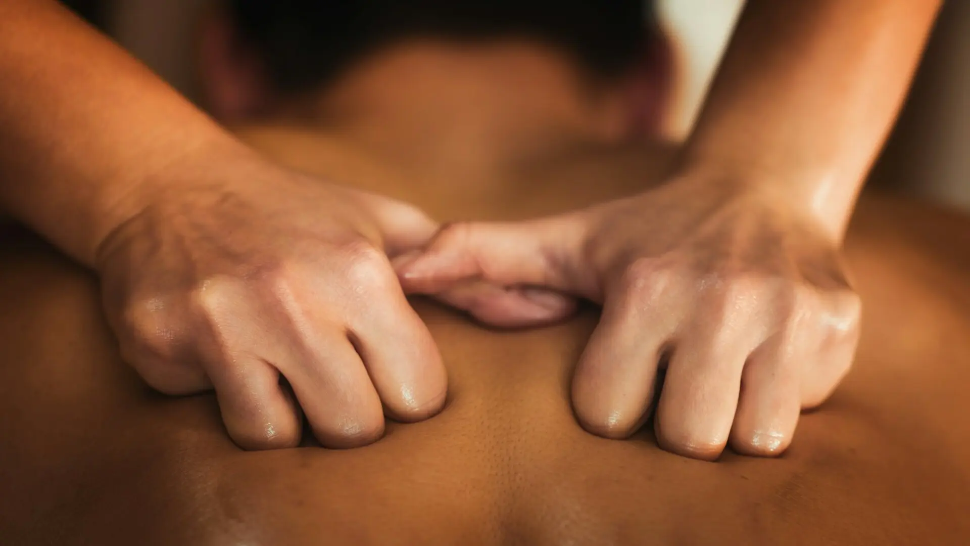 Close-up of hands giving a back massage